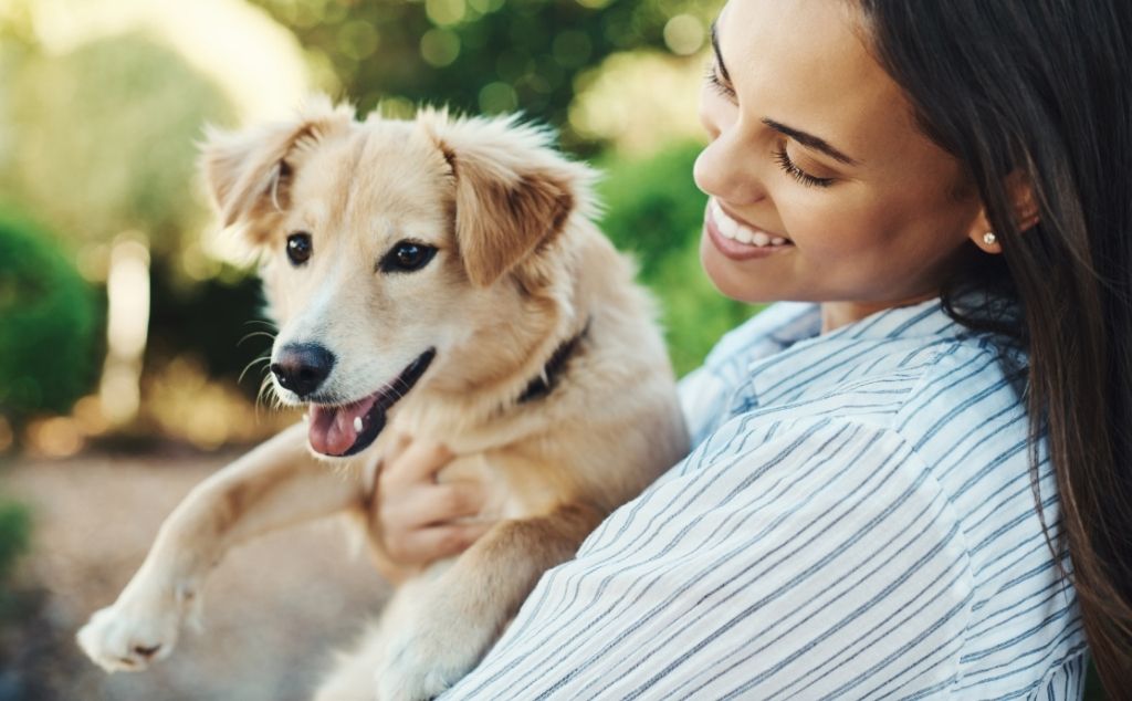woman holding emotional support dog