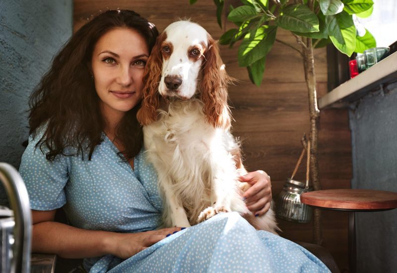woman with emotional support dog on lap