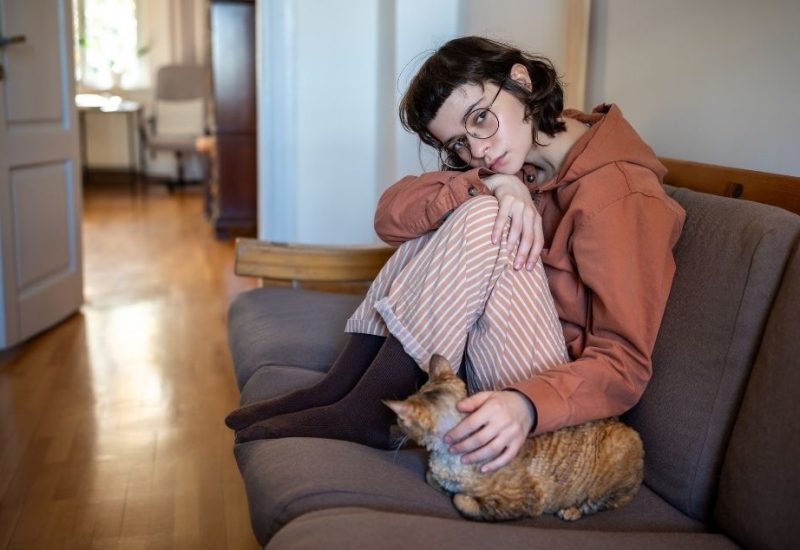 girl petting emotional support cat