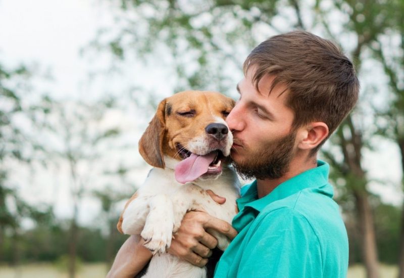 guy kissing dog